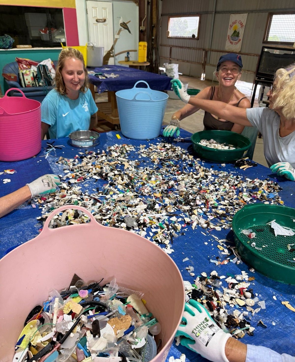 Volunteers sorting and counting marine debris at a cleanup table on Christmas Island, photographed by Renee Mouritz
