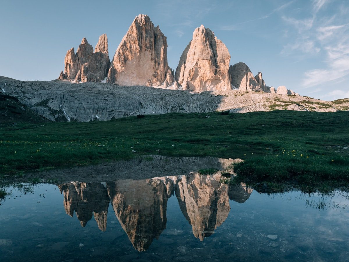 The three peaks of Tre Cime di Lavaredo reflected in an alpine pool